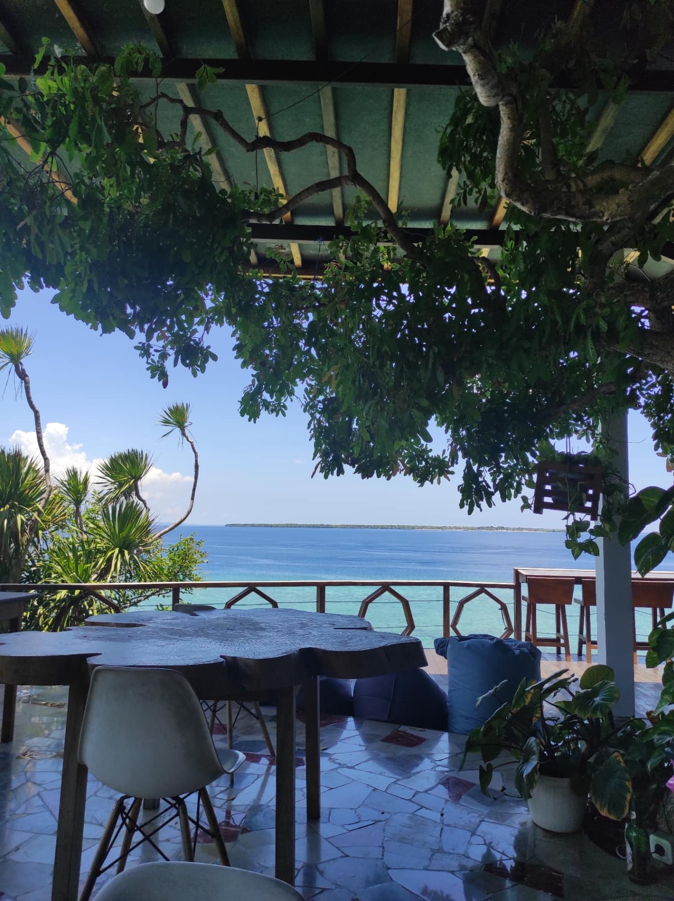 The open-air terrace of the Seascapes Bira restaurant, looking over the sea from the cliff at Bara Beach